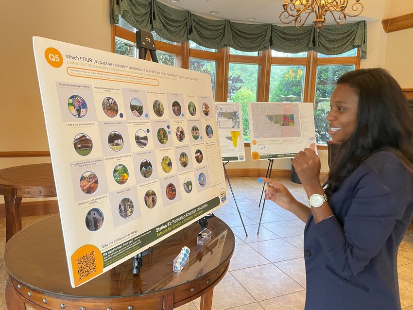 Commissioner Alexandra Compere answers the community survey for Veterans Park by placing a sticker on her top four favorite features she envisions. Residents are encouraged to answer the survey online.