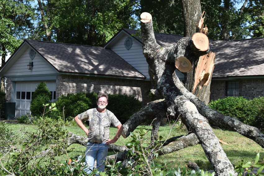 Ashby Graves didn't hear the giant branch snap from an old tree in his yard and land in his neighbor's driveway, but he was happy it didn't hit anything.