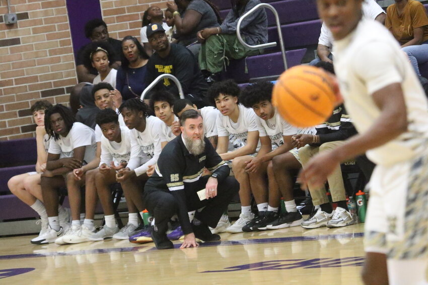 Oakleaf High basketball coach Jason Price tries to figure strategy to keep early lead in Knight's district championship against Fletcher. Knights lost 33-30 after leading for most of the game.