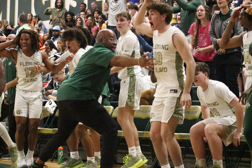 Fleming Island bassketball assistant coach Bruce Griner tries to corral his bench as the final seconds tick off the clock in Golden Eagles district championship win over Orange Park.