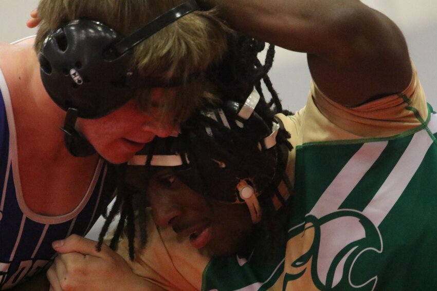 top photo for front page  Fleming Island wrestler Zion Longmire grapples with Clay High's Landon Martin in district 3-2A wrestling semifinal won by Longmire 12-11 in overtime. Longmire and Martin both advance to regions this week at Tallahassee Lincoln.