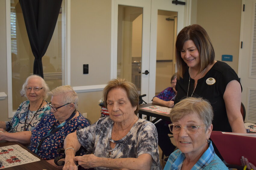 Sales and Marketing Director Ashley Robinson watches as residents of Palagio Senior Living play Bingo.