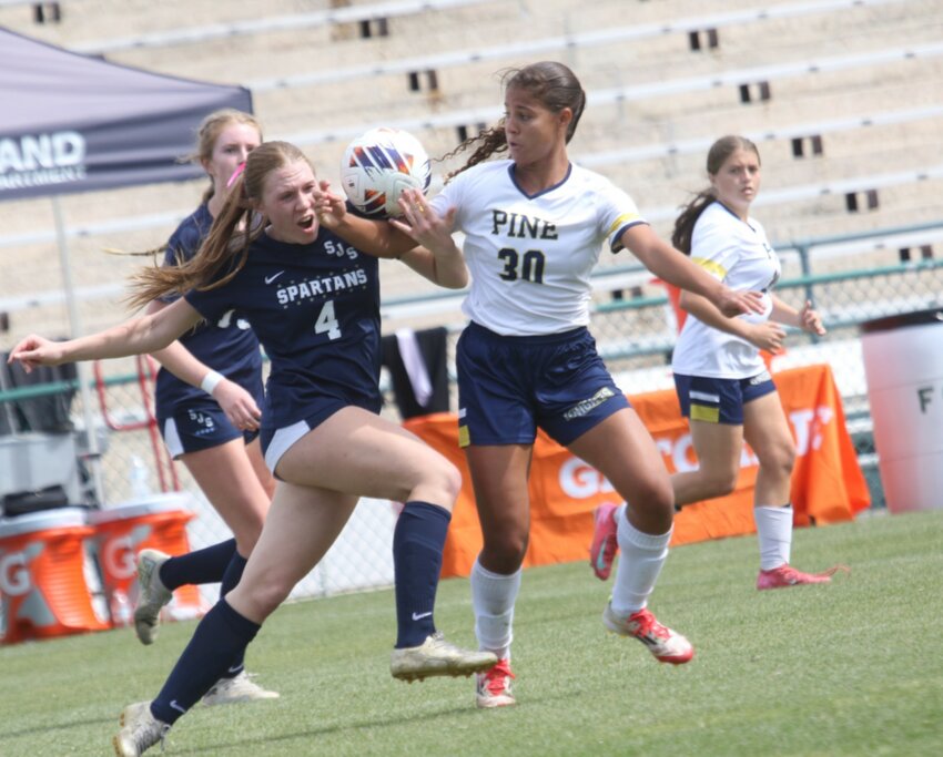 St. Johns Country Day School freshman defender Annabelle Ernst, in blue, battled with the USA's top goal scorer, Pine School's Giovanna Wakson, No. 30, who had 87 goals for the season, and was integral part of Spartans' 4-0 Class 1A championship win Saturday in Deland.