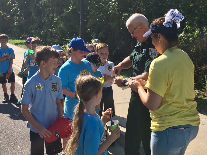Sheriff Michelle Cook said that connecting with the community is an instrumental part of the sheriff's office's success. Sgt. Ed Kroh interacts with children to gain their trust.