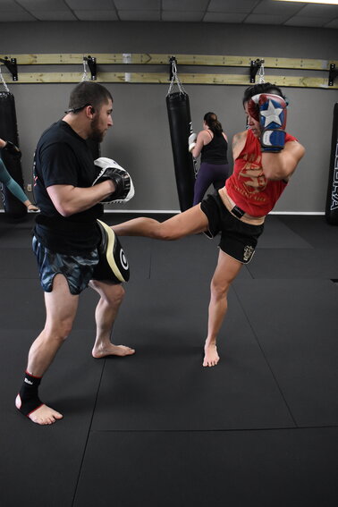 Jax Kickboxing Academy's Najeeb Mirza worked with Liz Hendrickson during the gym's opening Saturday at the new location at 1980 Wells Road.