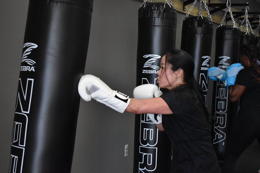 Rena Howell gave the heavy bag a workout after returning to kickboxing training last Saturday.