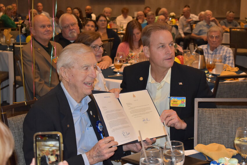 Frank N. James, left, holds proclamations by U.S. Senators Rick Scott and Marco Rubio during his 100th birthday party, which Rotary Club of Orange Park's Jack Scorby presented during Tuesday's meeting.