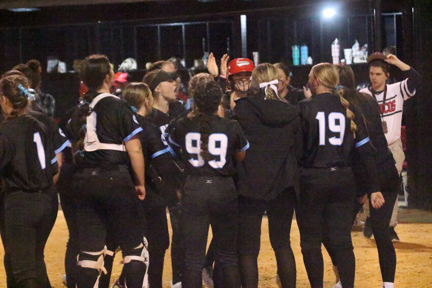 Middleburg High's softball team greets home run hitter KK Hagan, red helmet, after her solo homer against Oakleaf in Broncos' 2-0 win on Thursday, March 6.