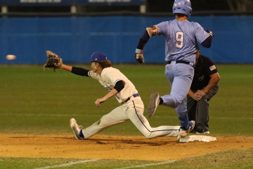 Clay High first baseball Rylan McMahan stretches to get out on St. Johns batter Brayden Harris in Spartans 3-2 win Friday night at Clay High.