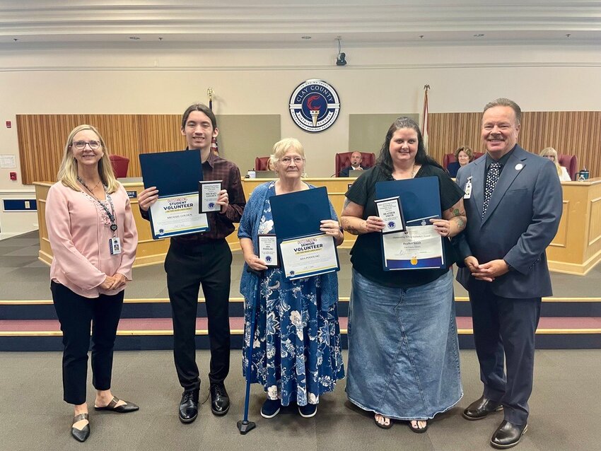 From left, Karen McMillan, coordinator of Family and Community Engagement for Clay County District Schools, joined Student Volunteer of the Year Michael Golden of Keystone Heights, Senior Volunteer Ada Podolski at Ridgeview Elementary, Adult Volunteer Heather Smith at Middleburg Elementary and Superintendent David Broskie at the April 3 meeting.