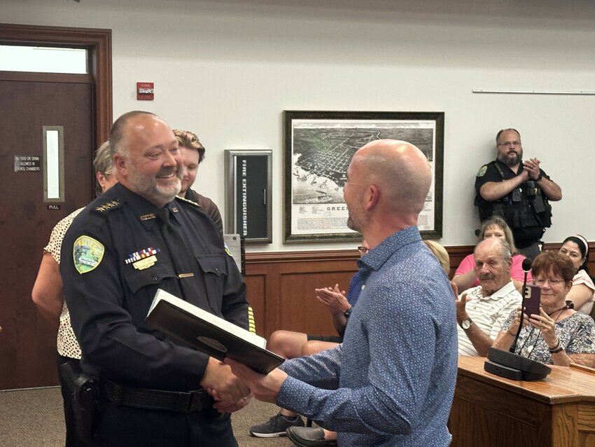 Green Cove Springs Mayor Steven Kelley congratulates Shawn Hines after his swearing-in as the city's new police chief Tuesday night.