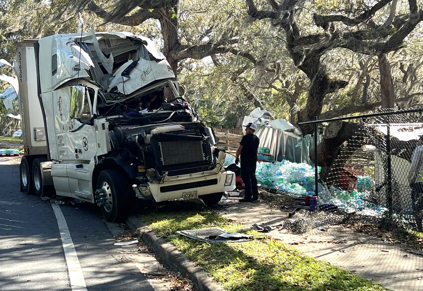 A semi-truck overturned in Keystone Heights on Highway 21 on Saturday morning, taking out the city fencing and spilling cases of water, resulting in a road closure until 6 p.m. The incident occurred at 5:45 a.m. According to the Clay County Sheriff's Office, the truck driver was speeding around a corner on Highway 21 when the cases of water shifted, causing him to crash into a tree and overturn. A substantial portion of the city fencing was removed. &quot;I am very thankful that no one was injured in this accident. We will have to review our options for securing the park until the fence is replaced,&quot; said Nina Rodenroth, City of Keystone Heights mayor.
