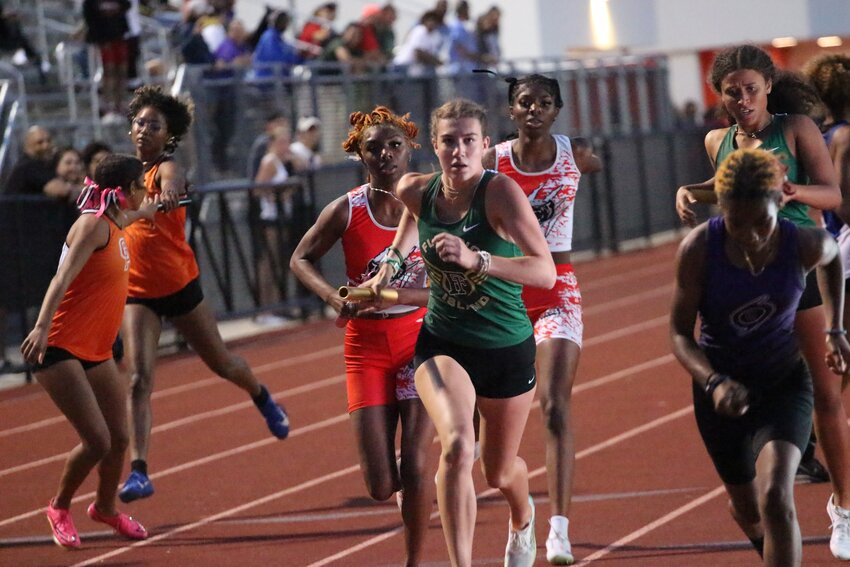 Fleming Island distance runner Brooke Reynolds takes final lap around Don Hall Track at Orange Park High School to stretch Golden Eagles' one point lead over Ridgeview to six point district title, 140-134.