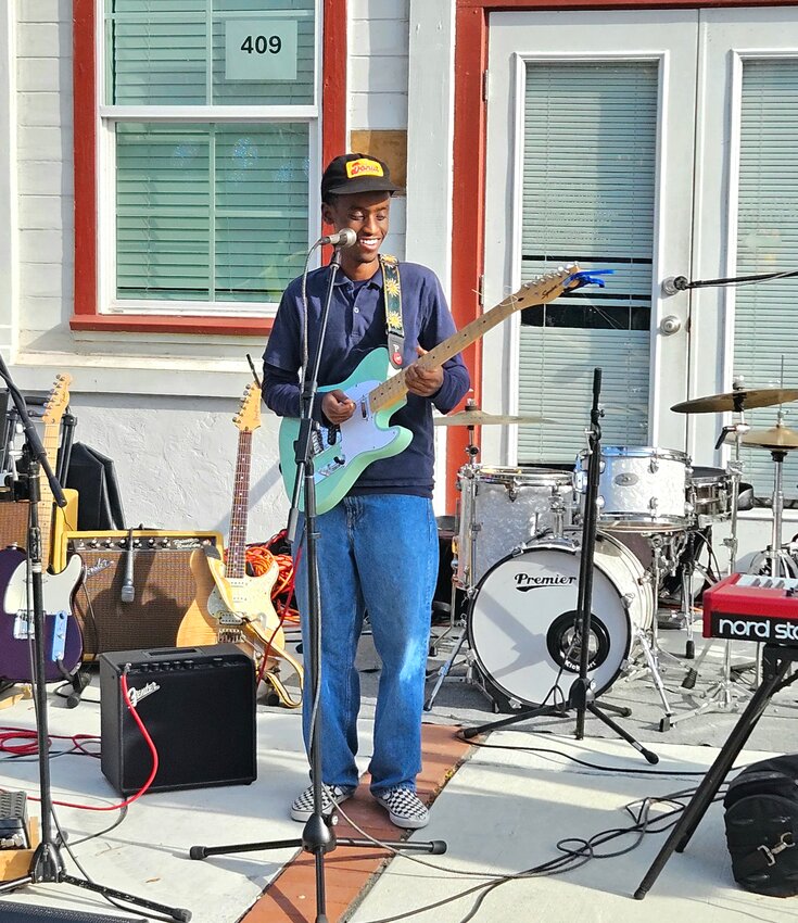 Three chords and the youth: Calvin Waiguru, 18, picking and grinnin'