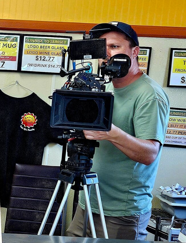 In focus: Director Justen Mann prepares a shot Monday at Sunrise to Sunset diner.