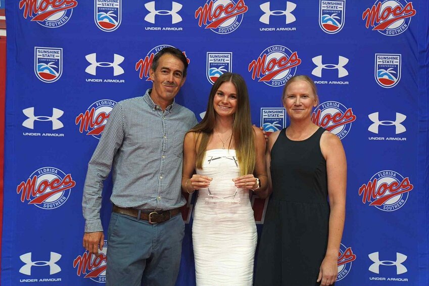 Former Middleburg High track and cross country standout Emma Mussante, center, holds the Pat McFadden scholar athlete award given to her for outstanding athletics as well as academics. With Mussante are FSC coaches Matt Levassiur and Stephanie Bylander.