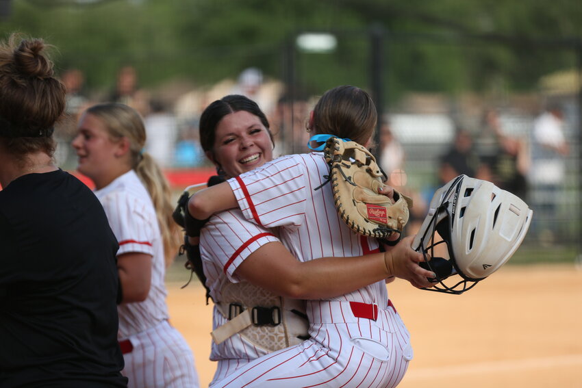 Middleburg High pitcher Cloey Ballinger embraces her catcher Madi Strickland after Ballinger finished off another no-hit inning in Broncos 5-1 region quarterfinal win over Milton on Thursday.  Middleburg advances to region semifinal against No. 2 seed Matanzas (22-1) and an 1-0 winner over Ponte Vedra in their quarterfinal.