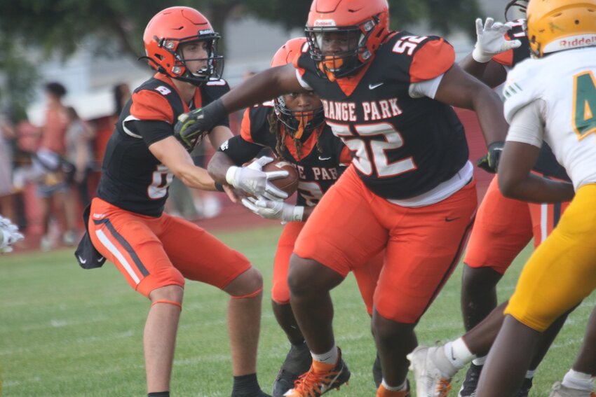 Orange Park quarterback Gabe Taylor hands off to running back Austeen Mills with lineman Jayden Blanton to lead the way in Raiders spring game against ED White.