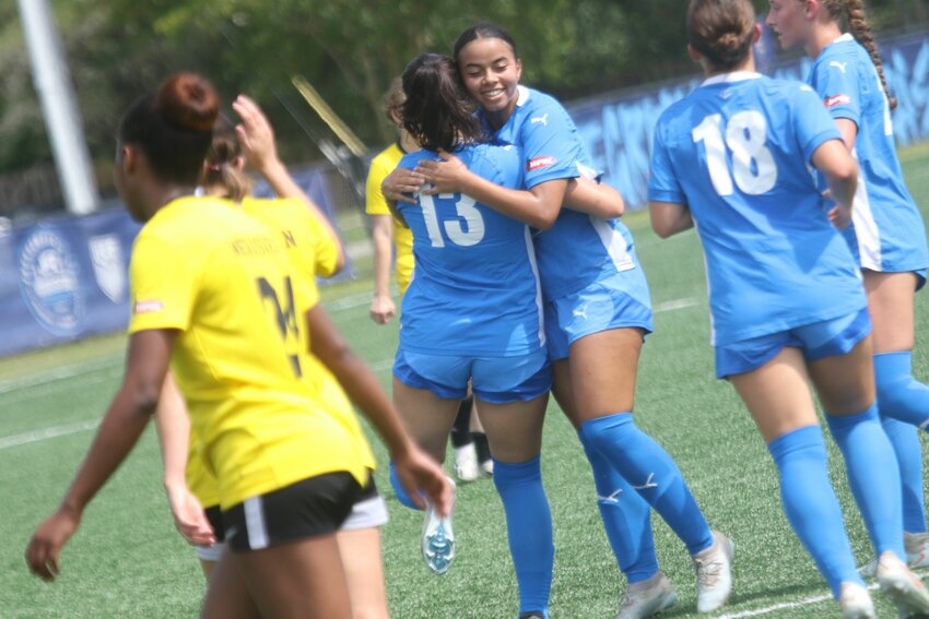 Two recent Clay County high school grads; Fleming Island's Sophia Pontieri, left, and Clay High's Brooke Bunton celebrate Pontieri's first half goal against FC Prime Time in Armada 5-0 win Saturday. Bunton served up Pontieri's goal and also scored a second half goal for the Armada.