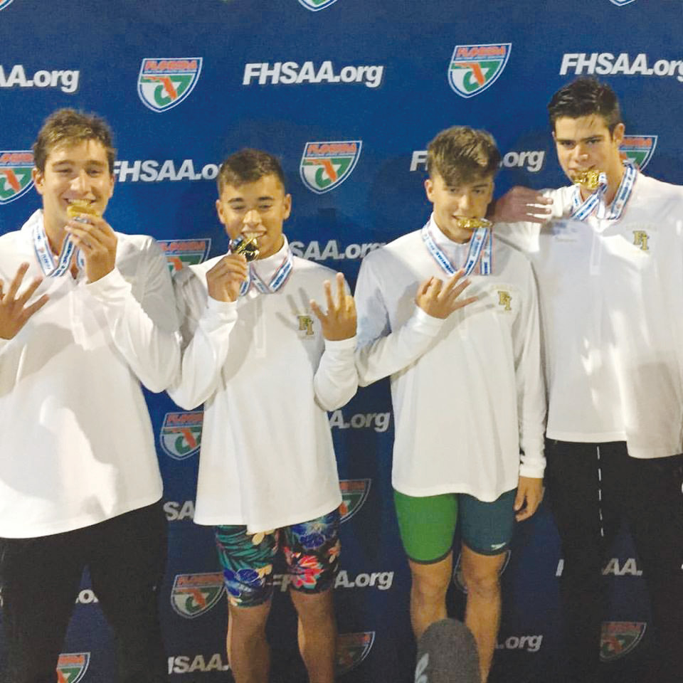 Fleming Island High’s boys 200 free relay team; left to right, Nick Hackett, Jack Neeley, Andrew Heinton and Jacob Thompson, pulled off a third straight gold medal performance at the Class 4A championships held November 10 in Stuart. See more coverage, page 22.