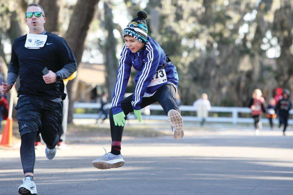 Ten year old Nick Santana jumps for joy at finish in 32:41 at Resolution Run 5K.