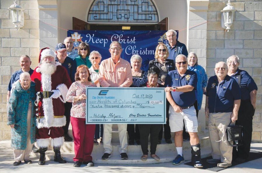 Santa Claus and Clay Electric gave the Knights of Columbus of Keystone Heights an early Christmas present with a $12,000 donation to support the club’s Holiday Helpers program, including Angel Tree requests to provide children with clothes and toys during the holidays.