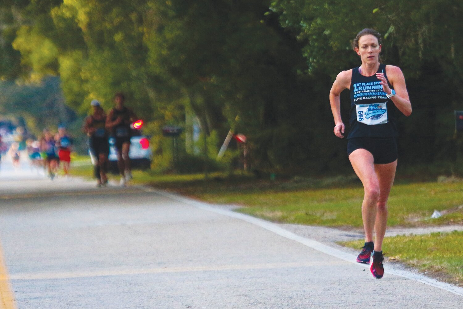 As a member of the 1st Place Sports elite racing team, Alexandra Midgett is seen here with a powerful stride in the Thanksgiving Day Distance Classic Half Marathon where she finished third female; and 21st overall.