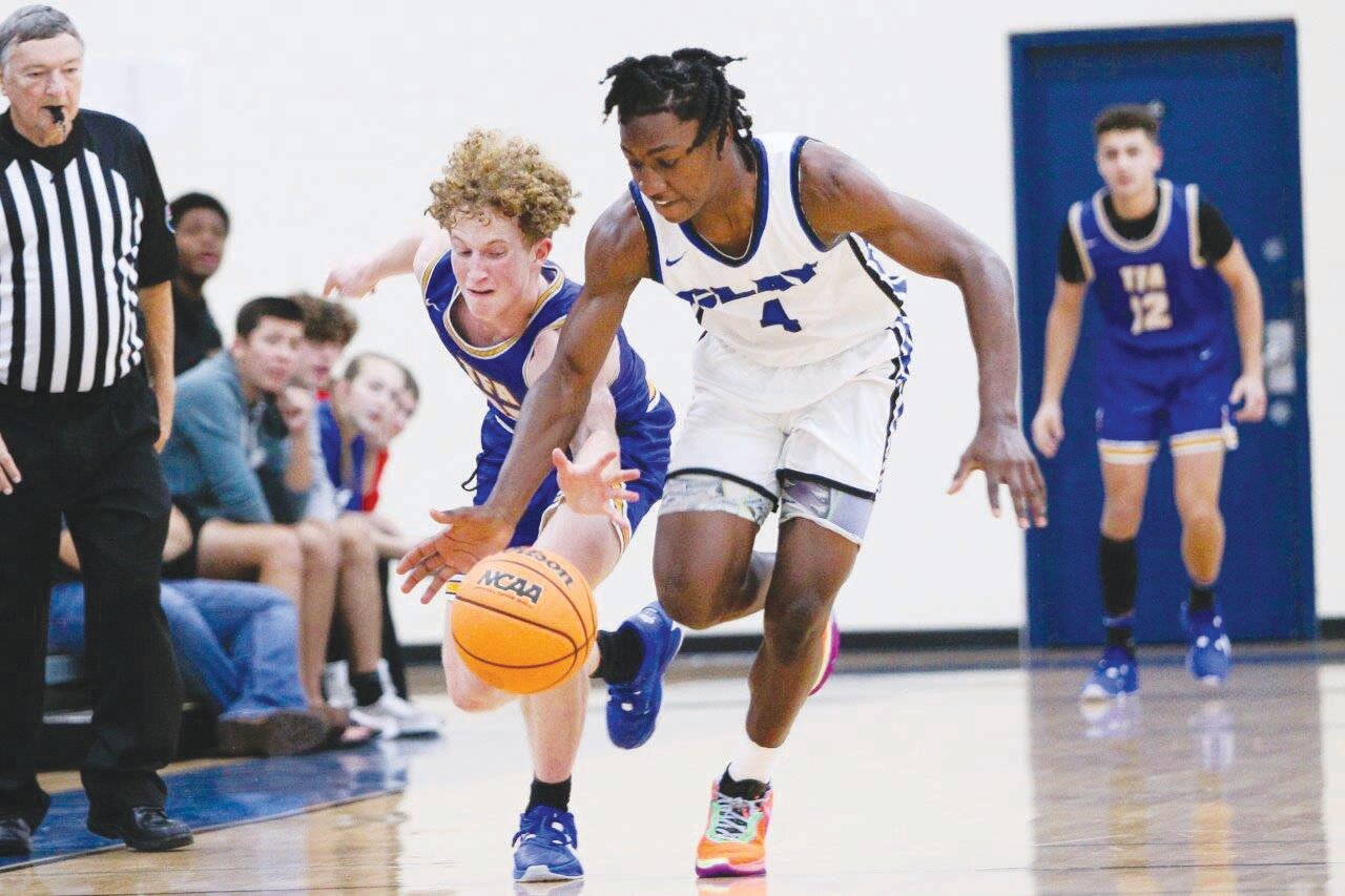 Clay guard D.J. Swilley fights for a loose ball against The First Academy.