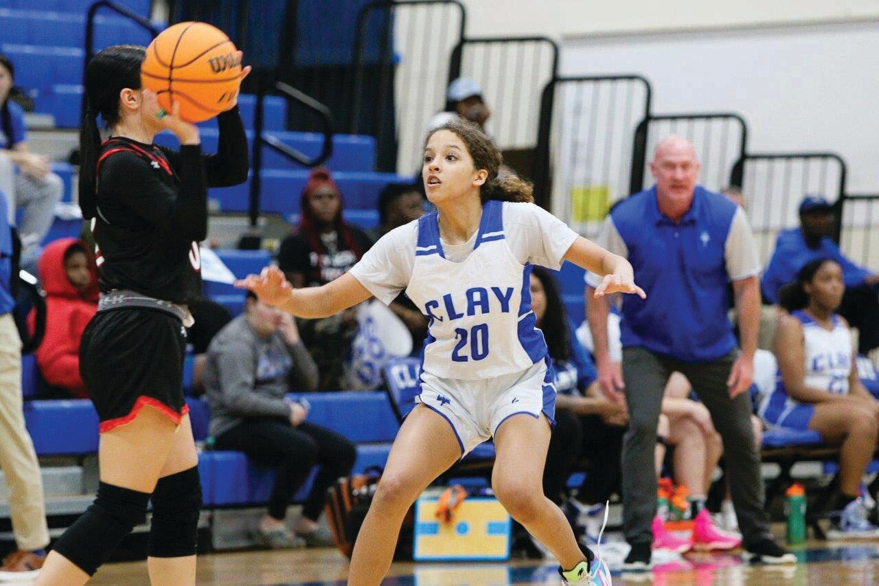 Clay forward Aiyana Haynes sets up the defense in front of Clay coach Doug Deters and the Blue Devils’ bench.