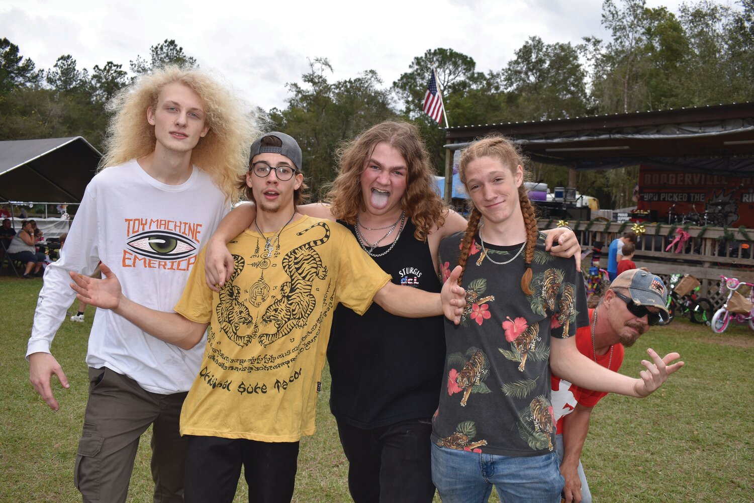 CBD members (from left) drummer Luke Parsons, guitarists and singers Austin “AJ” James and Henry Carter and bassist Matthew Hallowell get photobombed by Rockin’ For Stockins’ organizer Paul Wane after the band from Keystone Heights finished their set Sunday.