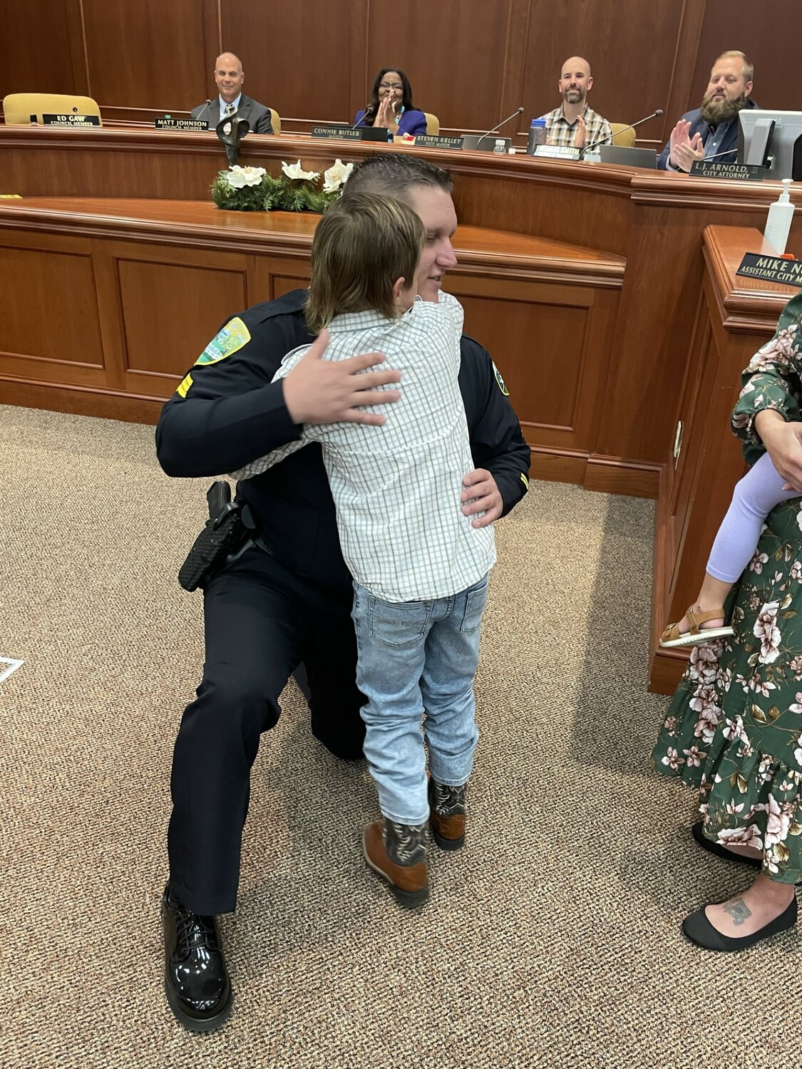 Sergeant Brett Morando hugged his son after his badge was pinned on.