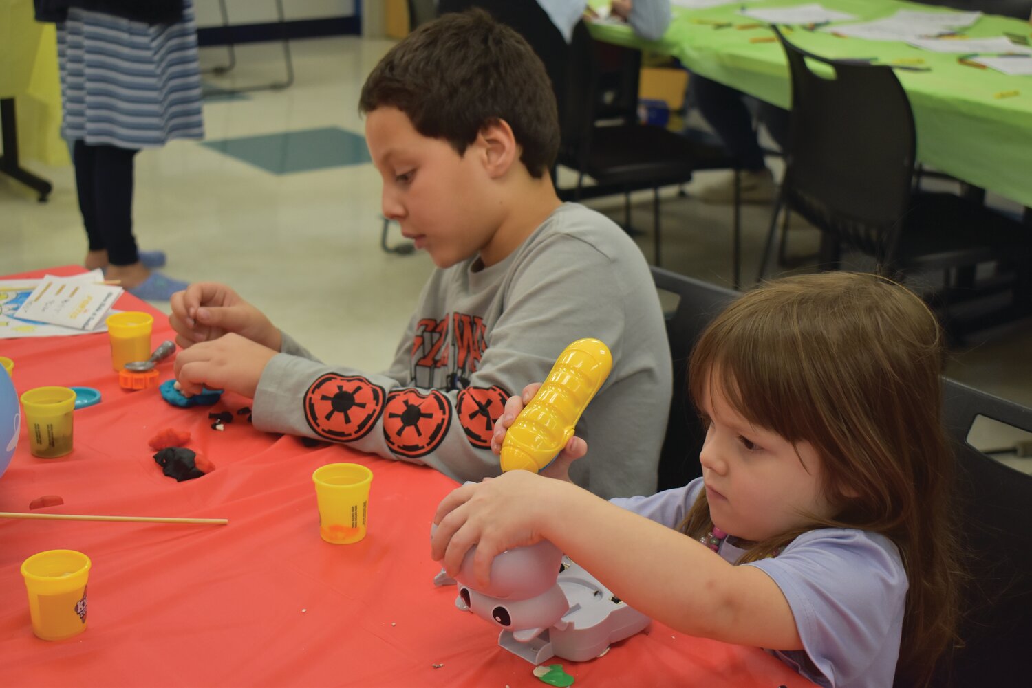 Part of the Give Kids a Smile Day is teaching children the importance of dental hygiene, Campus President Wyman Dickey said. Jaylea and Zachary used putty to create a tooth mold.