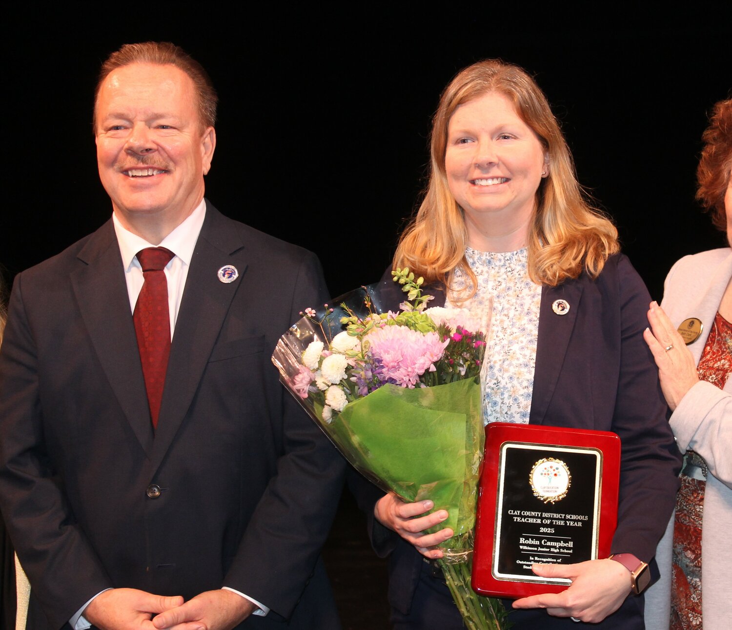 Wilkinson Junior High Science Teacher Robin Campbell won the Teacher of the Year award. Superintendent David Broskie (left) congratulated Campbell for her dedication in and outside the classroom.
