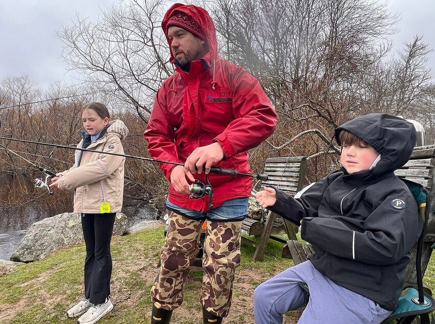 Westport resident Kevin McGoff fishes Grays Mill Pond Saturday morning with his daughter Carolyn and son Wesley.