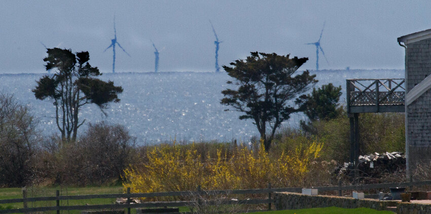 Wind turbines well offshore, as seen from the border of Little Compton and Westport last Friday.