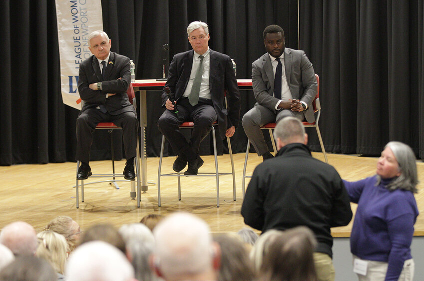 Sen. Jack Reed, Sen. Sheldon Whitehouse, and Rep. Gabe Amo (from left) listen to a constituent’s question during a congressional town hall sponsored by the League of Women Voters of Newport County at Portsmouth Middle School Monday night.