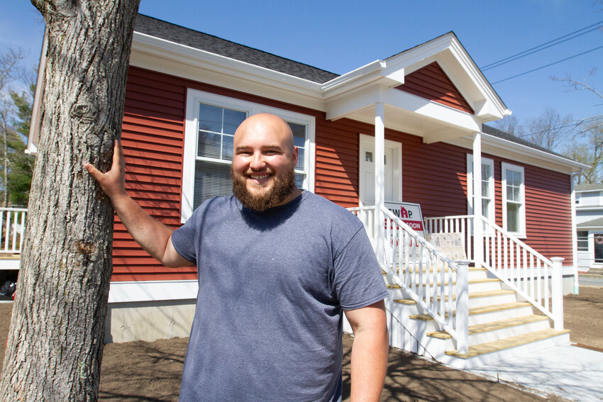 East Providence resident Tyler Benedetti, 26, stands by the home he now owns on Burnside Avenue in Riverside, which he was able to buy for $239,000 and includes an apartment that can be rented out to make additional revenue towards the mortgage.