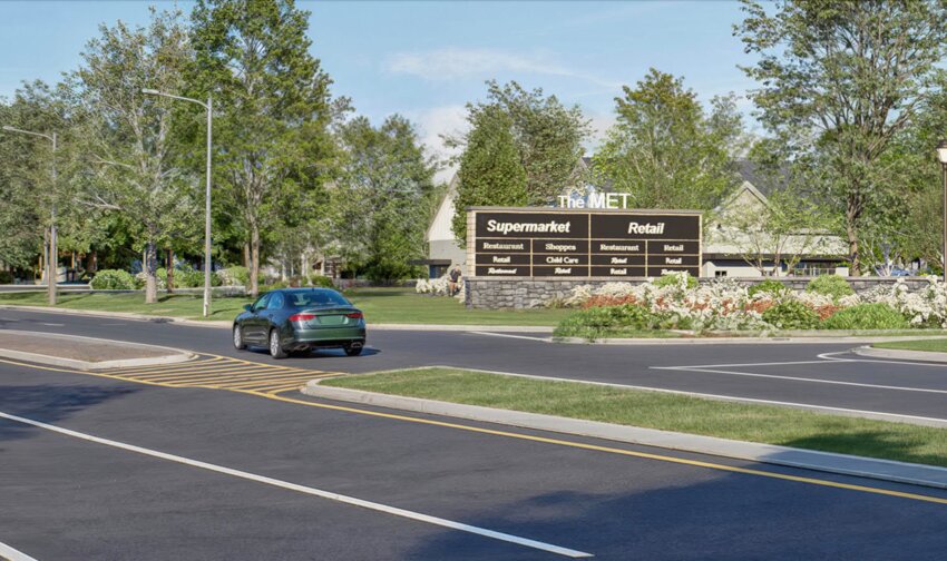 The redesigned signs, one at each planned entry to the development known as “The Met”, off Veterans Memorial Parkway. The Waterfront Commission had rejected a previous design that was 21 feet tall. The approved signs are 11 feet, seven inches tall.