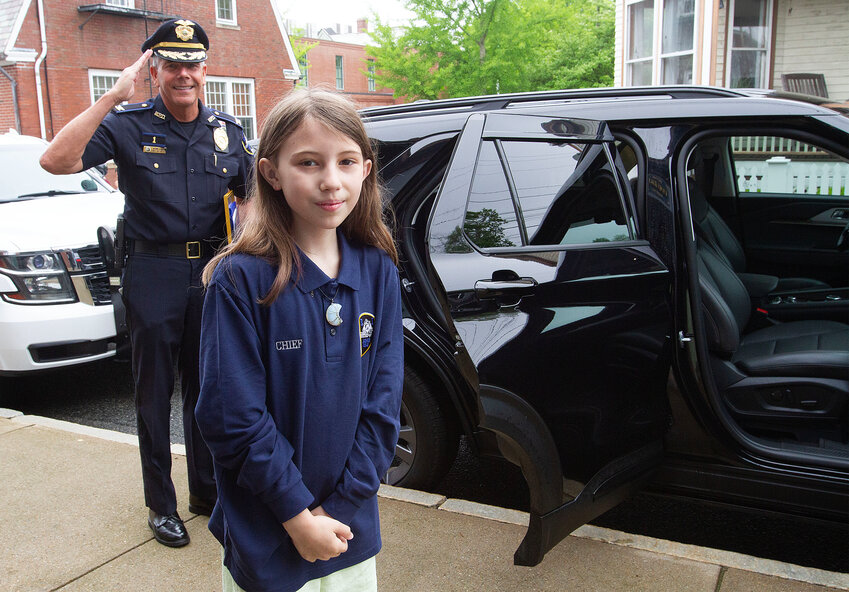Fourth-grader Isabella Crouse begins her busy day as ‘Chief for the Day’ as Chief Kevin Lynch salutes in the background. The day’s itinerary included a tour of several town departments, lunch at the Bristol House of Pizza, and a visit to Franklin Court.