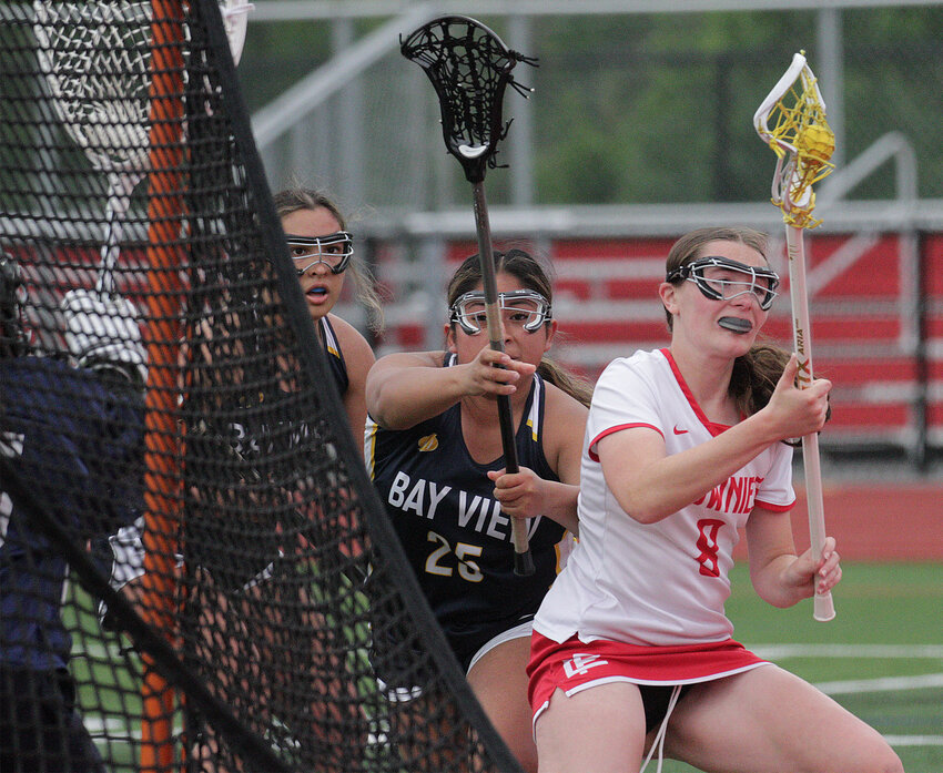 Senior Alyssa Karalekas (right) dekes a pair of defenders during the Townies win. 