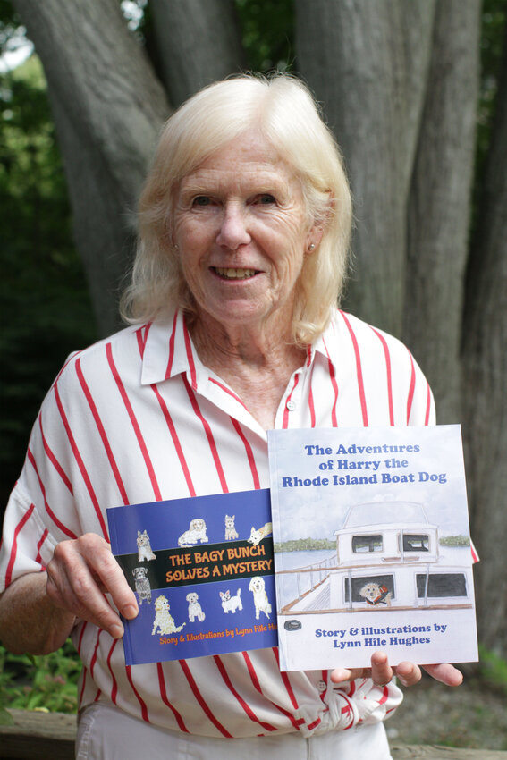 Lynn Hughes holds up the two books she has published in her lifetime — “The Bagy Bunch Solves a Mystery” and “The Adventures of Harry the Rhode Island Boat Dog.”