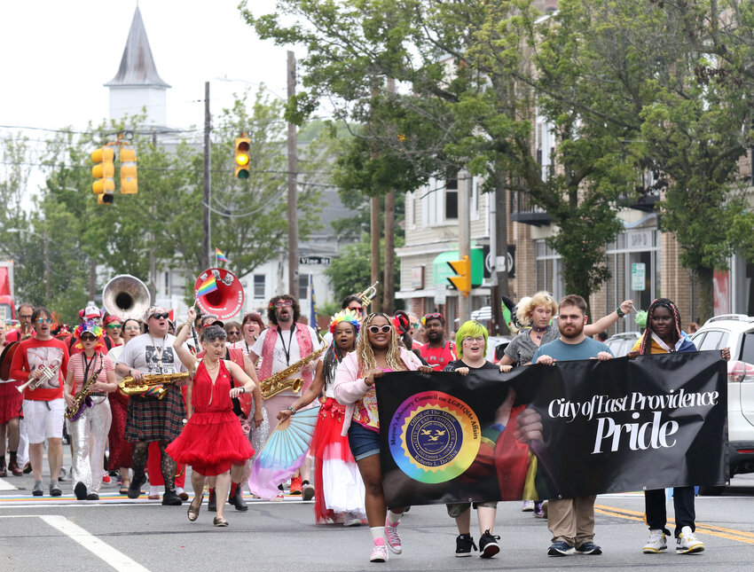 Marvin Campbell (left), Donovan Rhodes, Kai Reed and Sade Williams march in front of the parade with the city banner during the parade. 