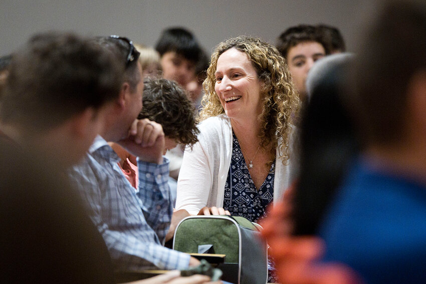 Educator Kerri Krawczyk smiles with her family, son Connor and husband Jason, while receiving applause for being named a national Presidential Awards for Excellence in Mathematics and Science Teaching finalist during a ceremony June 12 at Kickemuit Middle School.