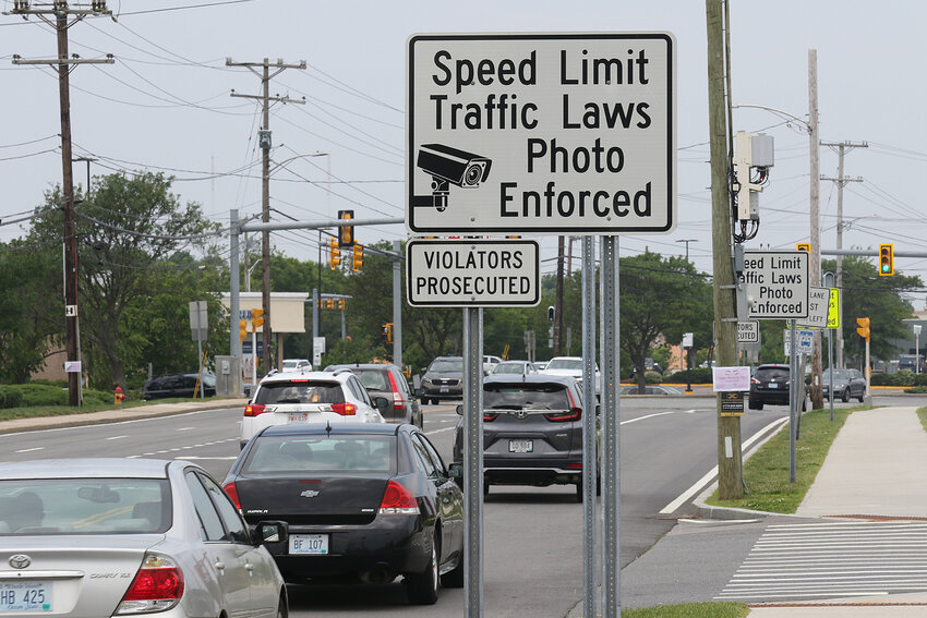 Signs warning motorists about speed cameras are posted along the road in front of East Providence High School. Barrington officials are considering the same approach for local school zones.
