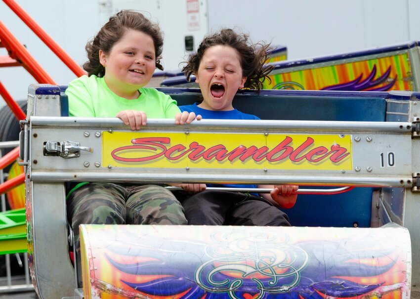 Patrick (left) and Rye Popores, ages 11 and 9 at the time, get some thrills while riding “The Scrambler” at the festival back in 2022.