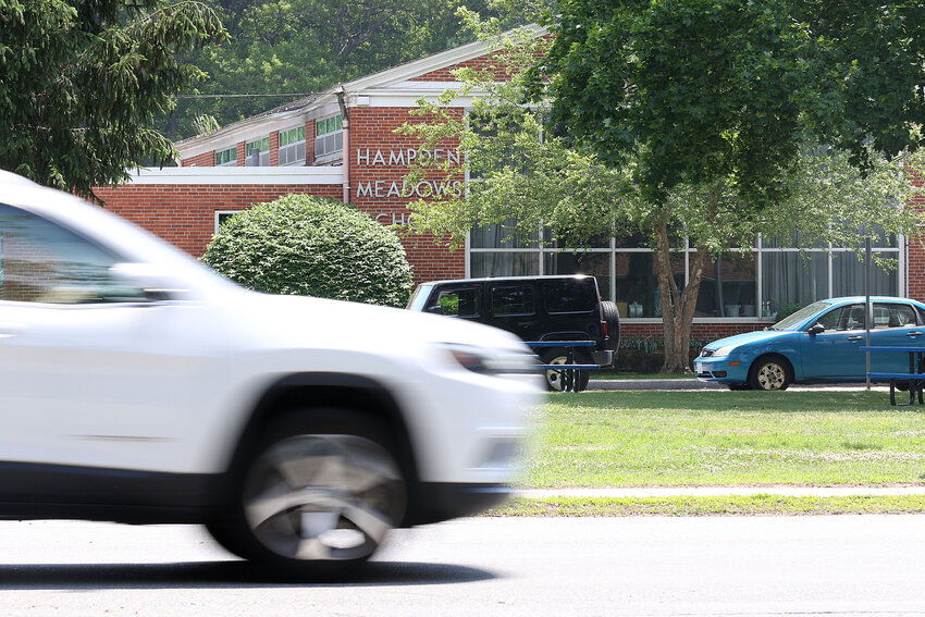 A car drives along New Meadow Road past Hampden Meadows School last week. Officials are exploring the idea of installing speed cameras in school zones.