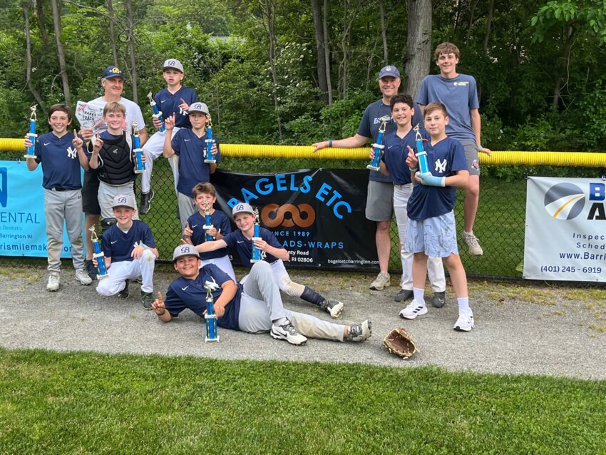 Members of the Bagels Etc. Yankees celebrate after winning the Barrington Little League Majors Division title.