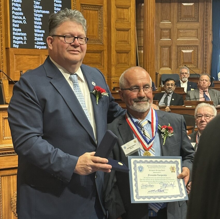 Fernando Larguinha, right, with Rep. Steve Ouellette of Westport at a recent ceremony at the Massachusetts State House in Boston.