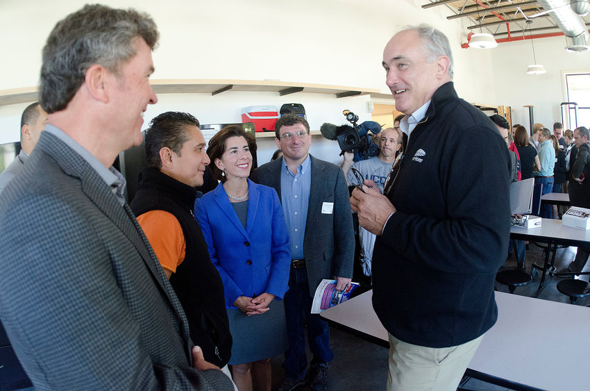 WaterRower CEO Peter King talks to then-Gov. Gina Raimondo and others during a tour of their Warren facility several years ago.