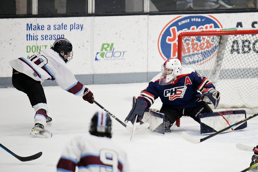 PHS goalie Jonathan Cabral stops an East Greenwich shot.